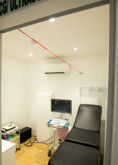 Private ECG and ultrasound room with exam bed and ultrasound machine